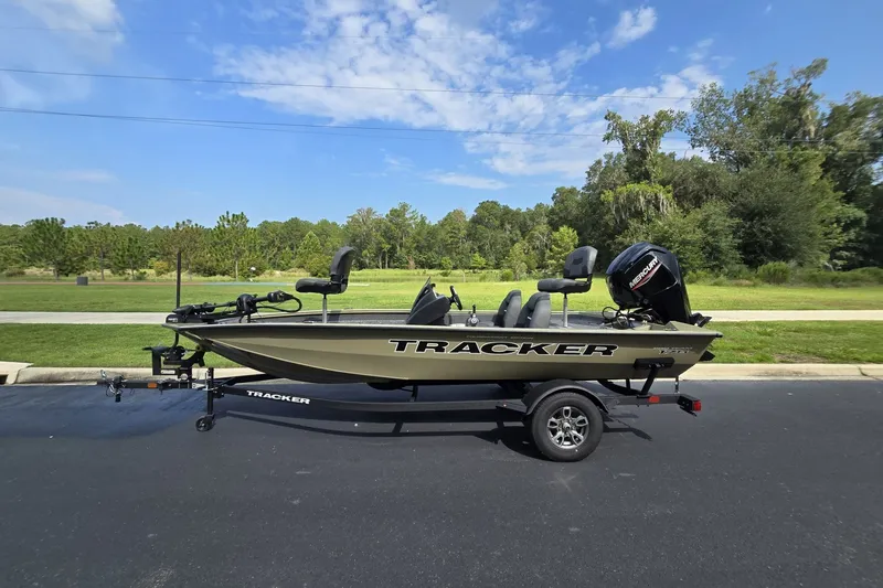 The Image of 2026 Tracker Pro Team 175 boat on trailer, parked outdoors under a clear blue sky. - 0