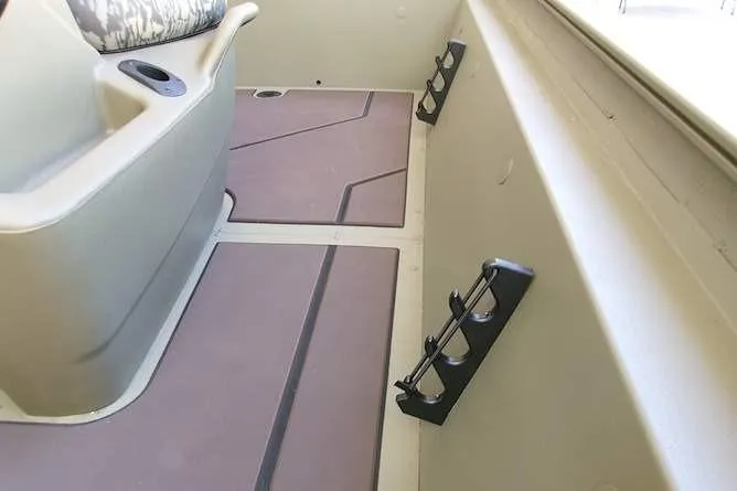 Slide: The Image of Interior of 2026 Tracker Grizzly 1860 CC boat with rod holders and seating. - 10