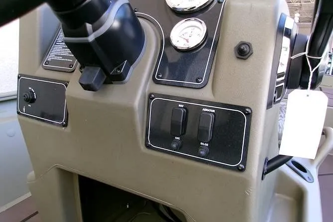 Slide: The Image of Control panel of 2026 Tracker Grizzly 1860 CC boat with gauges and switches. - 9