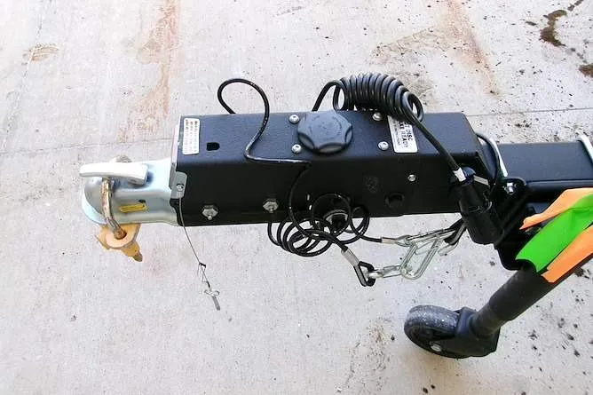 Slide: The Image of Trailer hitch of 2026 Tracker Grizzly 1860 CC on concrete surface. - 11