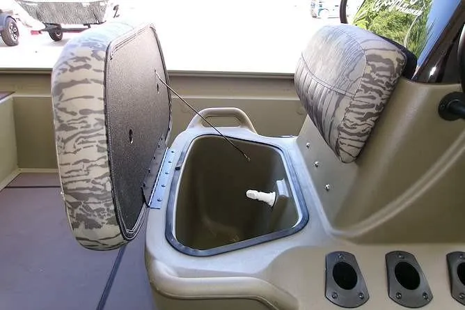 Slide: The Image of 2026 Tracker Grizzly 1860 CC boat interior with open storage compartment and seating. - 6