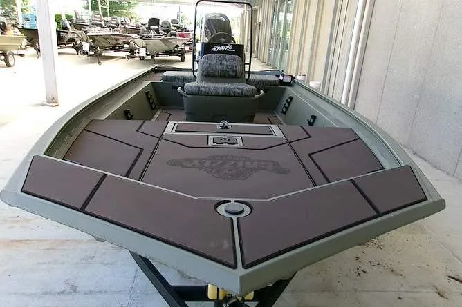 Slide: The Image of 2026 Tracker Grizzly 1860 CC boat with spacious deck and seating, ideal for fishing. - 4