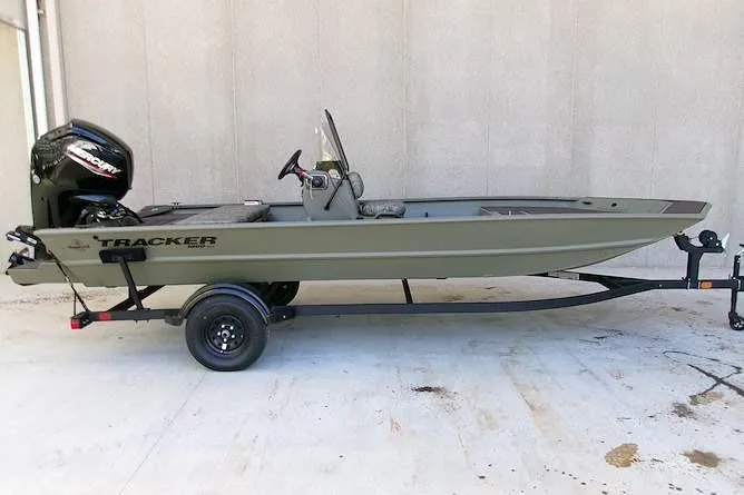 The Image of 2026 Tracker Grizzly 1860 CC boat on trailer, side view, outdoors. - 0