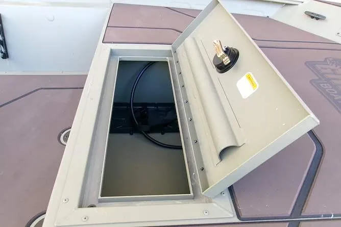 Slide: The Image of Open storage compartment on 2026 Tracker Grizzly 1860 CC boat deck. - 7
