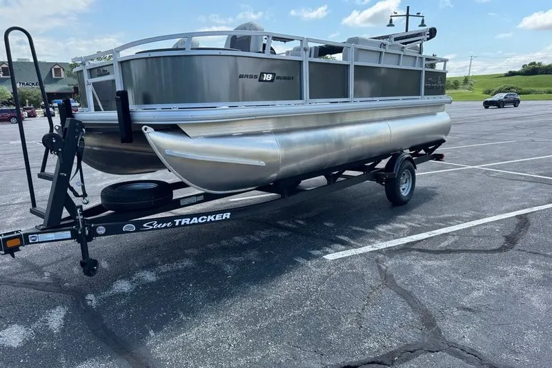 Slide: The Image of 2026 Sun Tracker Bass Buggy 18 DLX pontoon boat on trailer in parking lot. - 5