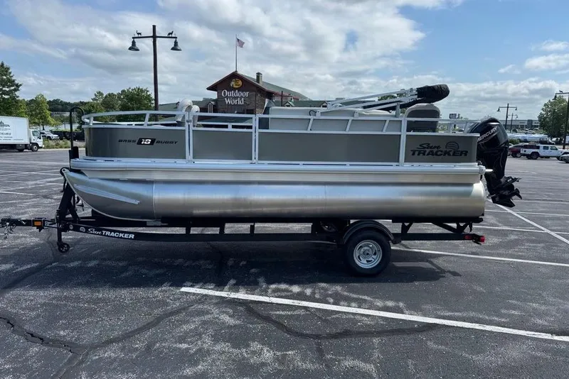Slide: The Image of 2026 Sun Tracker Bass Buggy 18 DLX pontoon boat on trailer in parking lot. - 85