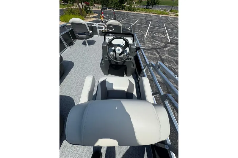 Slide: The Image of 2026 Sun Tracker Bass Buggy 18 DLX pontoon boat interior with steering console and seating. - 88