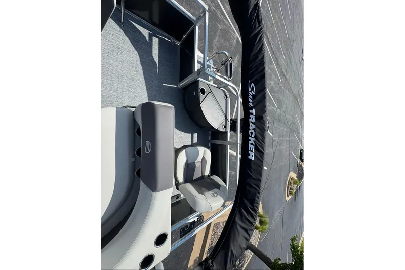 Slide: The Image of 2026 Sun Tracker Bass Buggy 18 DLX pontoon boat interior with seating and cover. - 89