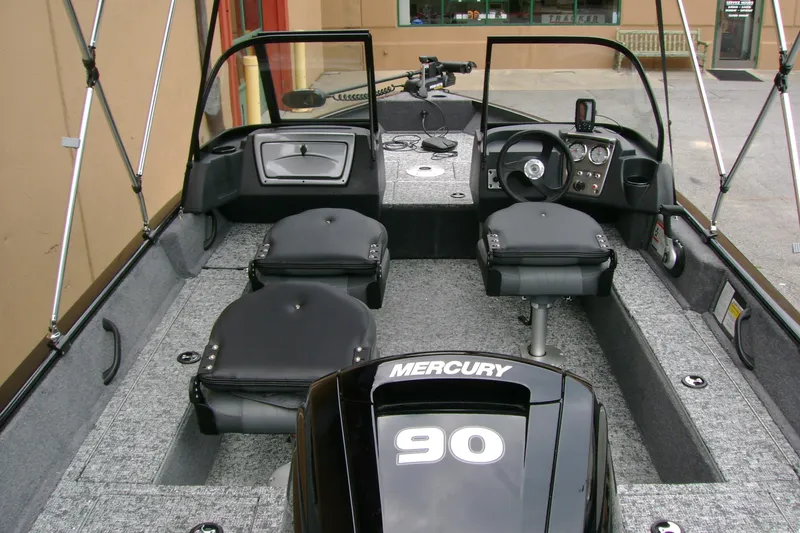 Slide: The Image of 2026 Tracker Pro Guide V-16 WT boat interior with Mercury 90 engine, featuring seating and controls. - 8