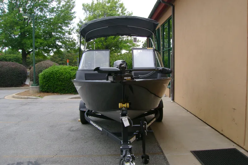 Slide: The Image of 2026 Tracker Pro Guide V-16 WT boat on trailer, parked outdoors. - 4