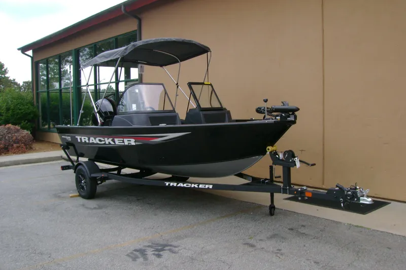 Slide: The Image of 2026 Tracker Pro Guide V-16 WT boat on trailer, parked outdoors. - 6