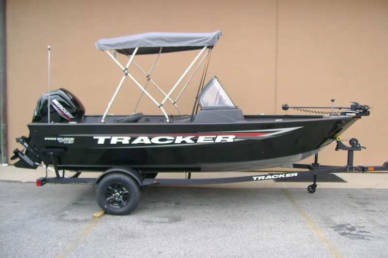 The Image of 2026 Tracker Pro Guide V-16 WT boat with canopy on trailer, side view. - 0