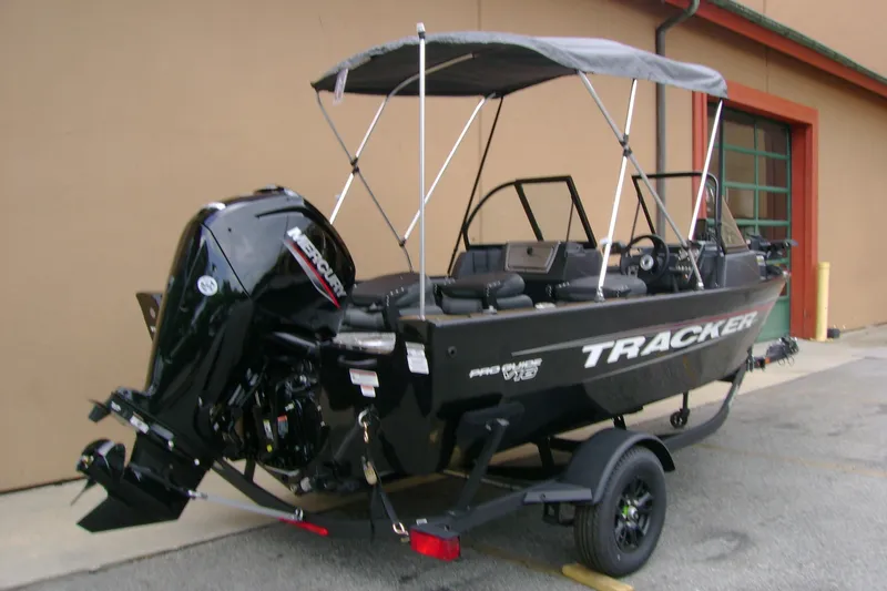Slide: The Image of 2026 Tracker Pro Guide V-16 WT boat with Mercury outboard motor, parked on trailer. - 3