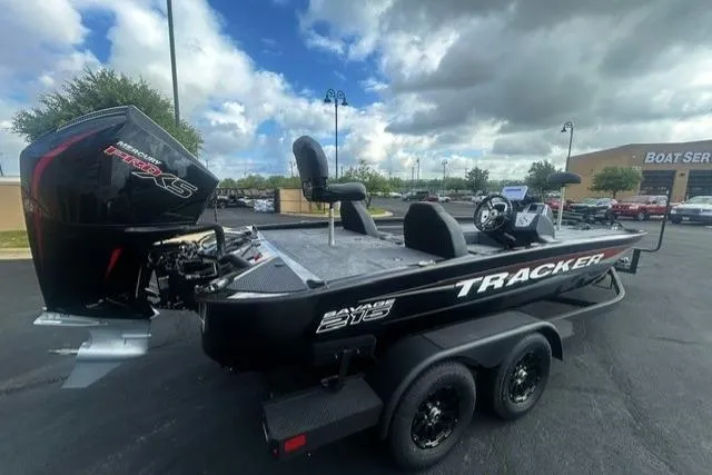 Slide: The Image of 2026 Tracker Savage 215 boat with powerful engine, parked outdoors under cloudy sky. - 3