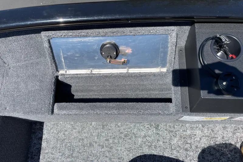 Slide: The Image of Interior view of 2026 Tracker Super Guide V-16 T boat, featuring storage and control panel. - 10