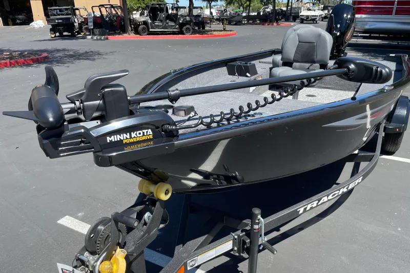 Slide: The Image of 2026 Tracker Super Guide V-16 T boat with Minn Kota PowerDrive motor in parking lot. - 4