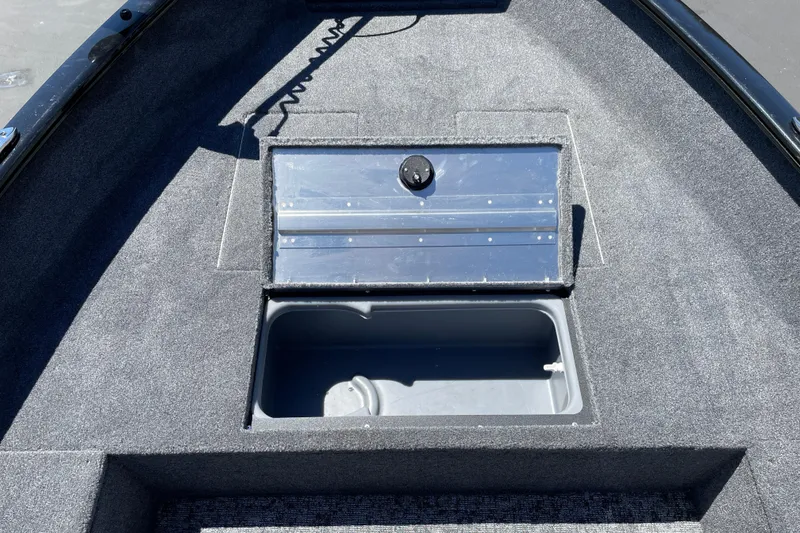 Slide: The Image of 2026 Tracker Super Guide V-16 T boat storage compartment with open lid. - 9