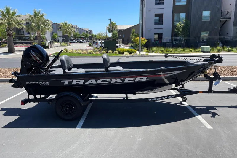 The Image of 2026 Tracker Super Guide V-16 T boat parked in urban setting, side view. - 0