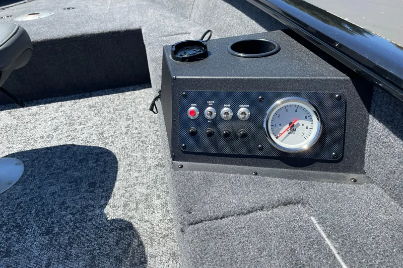 Slide: The Image of Control panel of 2026 Tracker Super Guide V-16 T boat with RPM gauge and switches. - 7