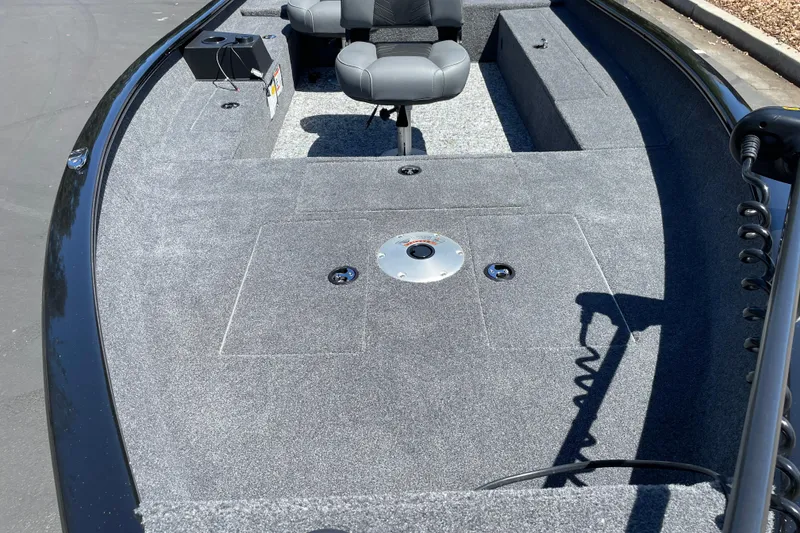 Slide: The Image of 2026 Tracker Super Guide V-16 T boat interior with seating and carpeted deck. - 5