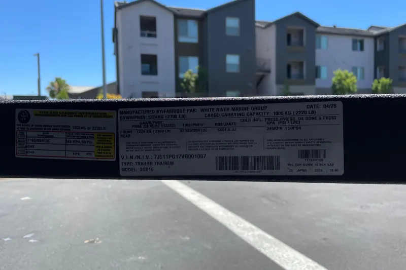 Slide: The Image of Label on Tracker Super Guide V-16 T trailer, 2026 model, with specifications and VIN details. - 44