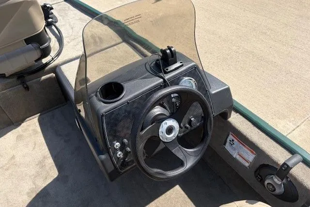 Slide: The Image of 2026 Tracker Bass Tracker Classic Limited boat dashboard with steering wheel and controls. - 3