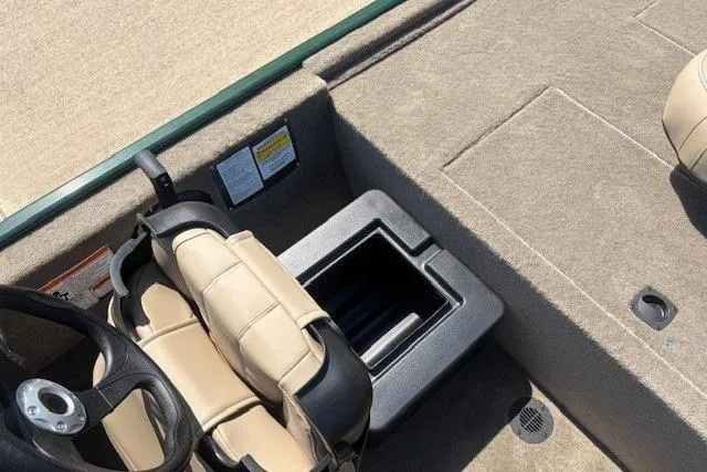 Slide: The Image of 2026 Tracker Bass Tracker Classic Limited boat interior with beige seating and storage compartment. - 4