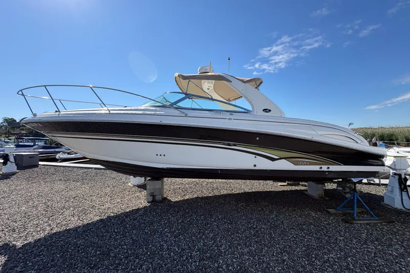 Slide: The Image of 2001 Sea Ray 290 Sun Sport boat on display under clear blue sky. - 3