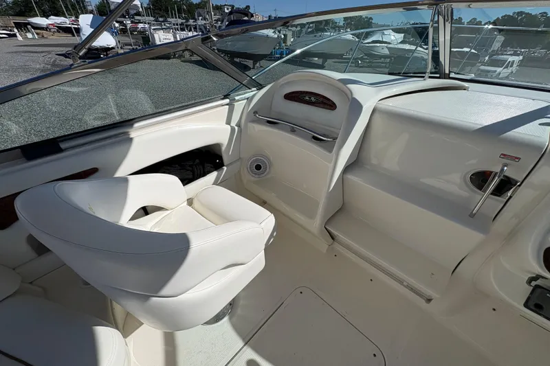 Slide: The Image of 2001 Sea Ray 290 Sun Sport boat interior with white seating and dashboard. - 13