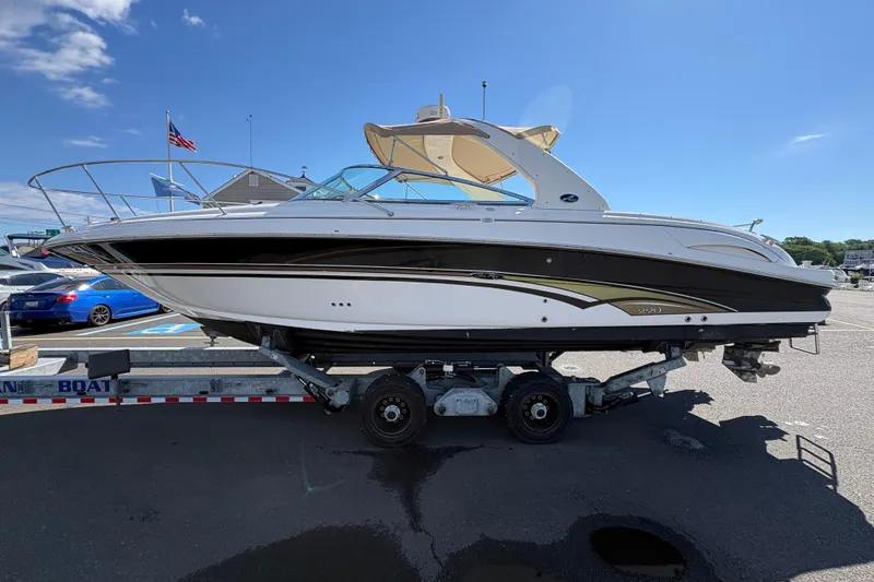 Slide: The Image of 2001 Sea Ray 290 Sun Sport boat on trailer under clear blue sky. - 6