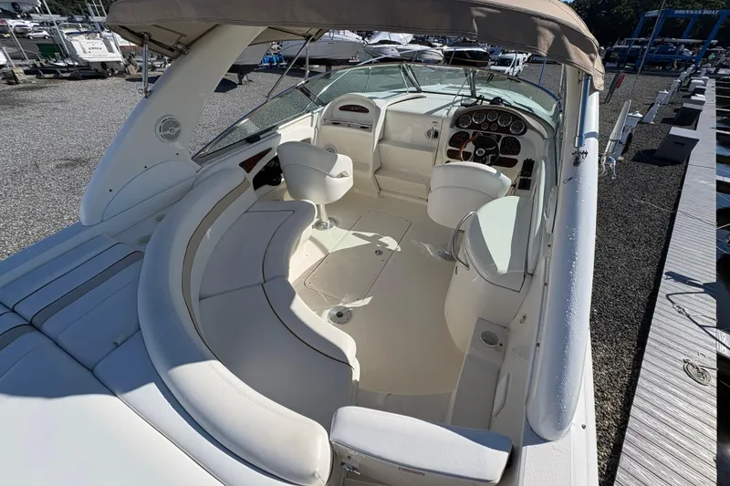 Slide: The Image of 2001 Sea Ray 290 Sun Sport boat interior with white seating and dashboard. - 10