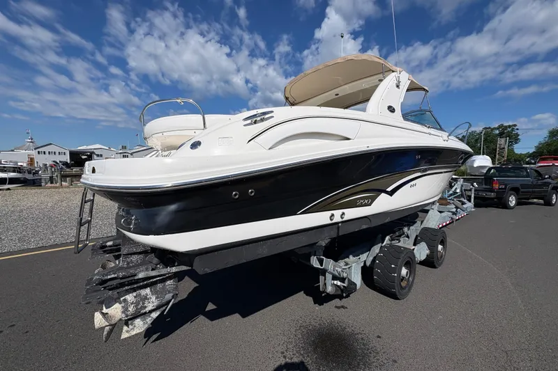 Slide: The Image of 2001 Sea Ray 290 Sun Sport boat on trailer under a clear blue sky. - 4
