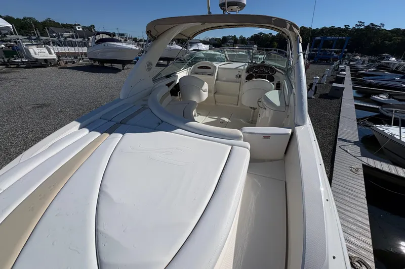 Slide: The Image of 2001 Sea Ray 290 Sun Sport boat docked at a marina, showcasing sleek interior design. - 9