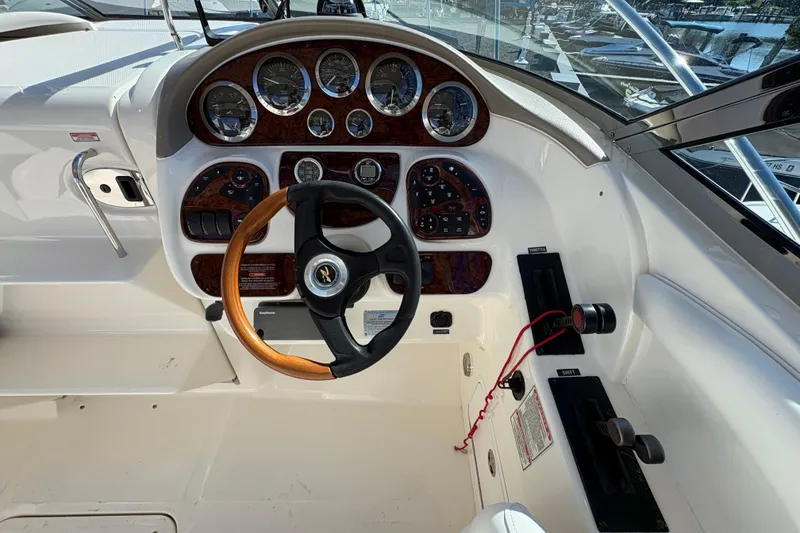 Slide: The Image of 2001 Sea Ray 290 Sun Sport dashboard with wood accents and steering wheel. - 14