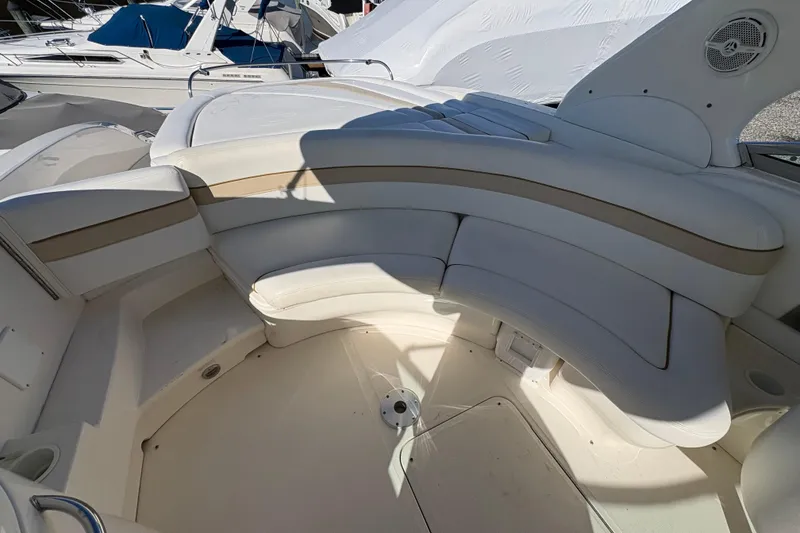 Slide: The Image of 2001 Sea Ray 290 Sun Sport boat interior with white seating and cup holders. - 11