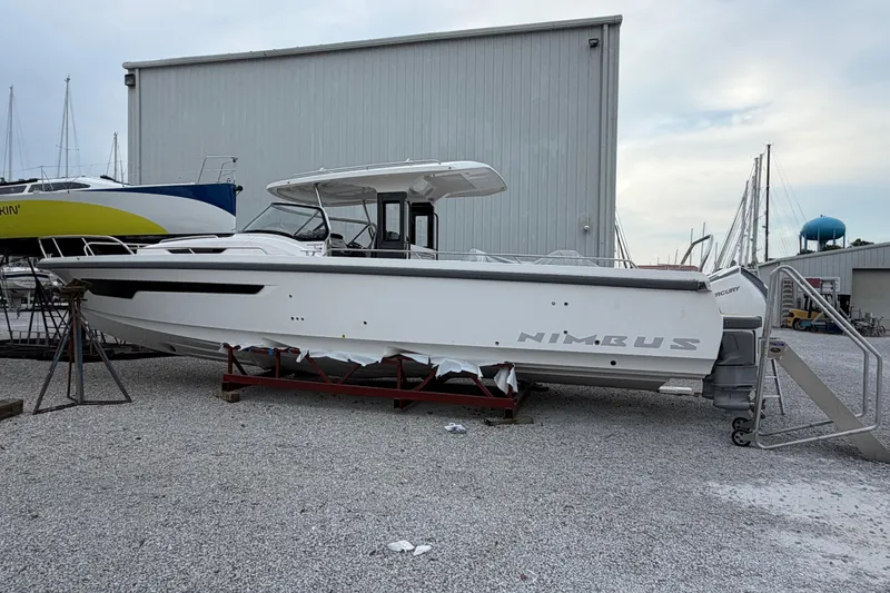The Image of 2025 Nimbus Tender 11 boat on dry dock, side view, in a marina setting. - 0