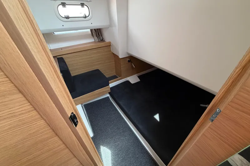 Slide: The Image of Interior cabin of 2025 Nimbus Tender 11, featuring sleek wood finishes and modern design. - 10