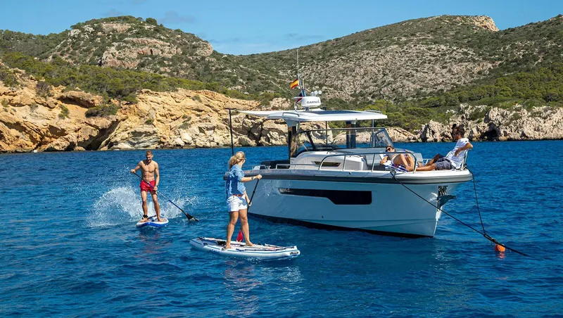 Slide: The Image of Manufacturer Provided Image: Nimbus Tender 11, 2025, on blue water with paddleboarders. - 11