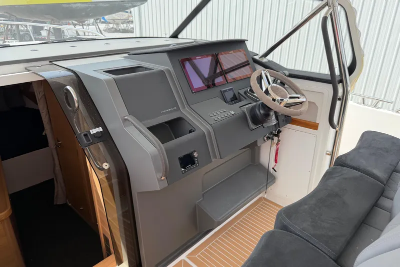 Slide: The Image of Interior cockpit of 2025 Nimbus Tender 11, featuring modern steering and control panel. - 17
