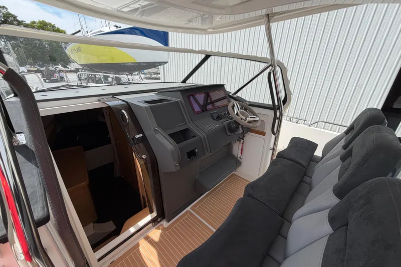 Slide: The Image of Interior of 2025 Nimbus Tender 11 boat with modern dashboard and seating. - 18