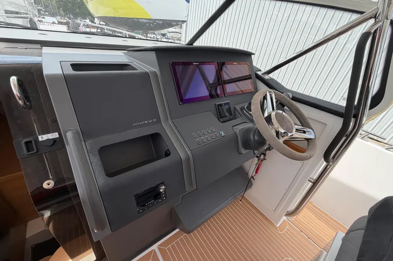 Slide: The Image of Cockpit of 2025 Nimbus Tender 11 with modern steering and control panel. - 19
