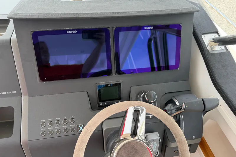 Slide: The Image of Cockpit of 2025 Nimbus Tender 11 with dual Simrad displays and steering wheel. - 20