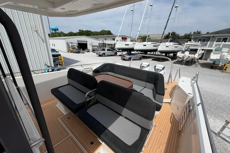 Slide: The Image of Nimbus Tender 11 (2025) boat interior with seating, docked at a marina with other boats. - 23