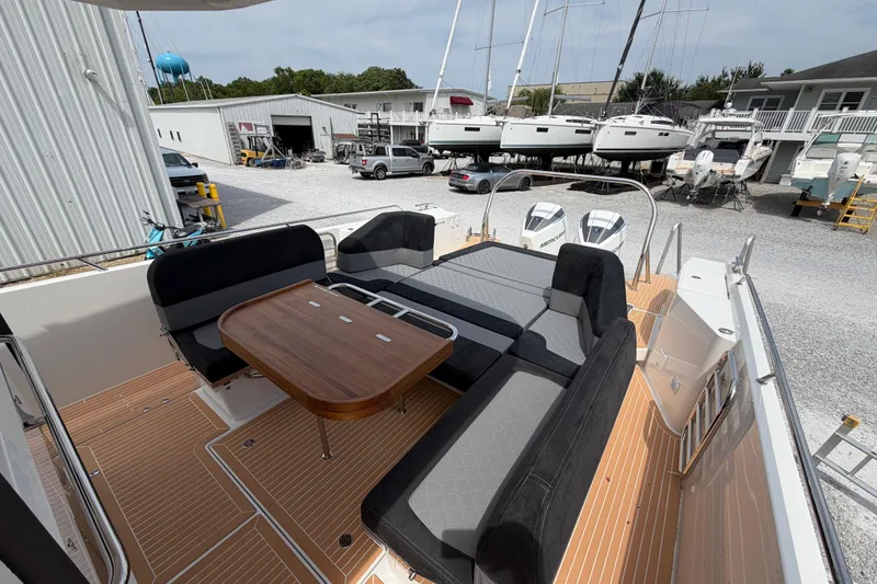 Slide: The Image of Luxurious 2025 Nimbus Tender 11 boat interior with sleek seating and wooden table. - 24