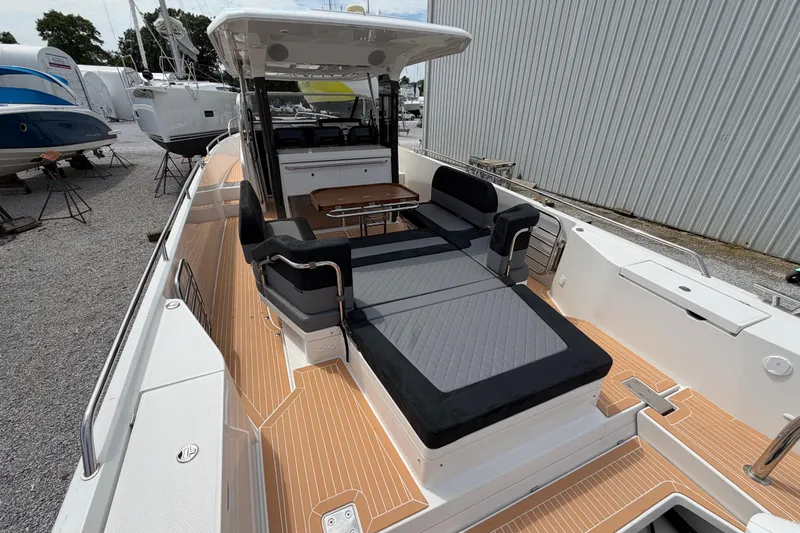 Slide: The Image of 2025 Nimbus Tender 11 boat with spacious deck and luxurious seating. - 25