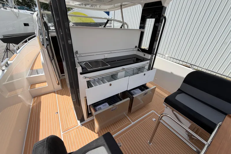Slide: The Image of 2025 Nimbus Tender 11 boat interior with sleek kitchen and seating area. - 3