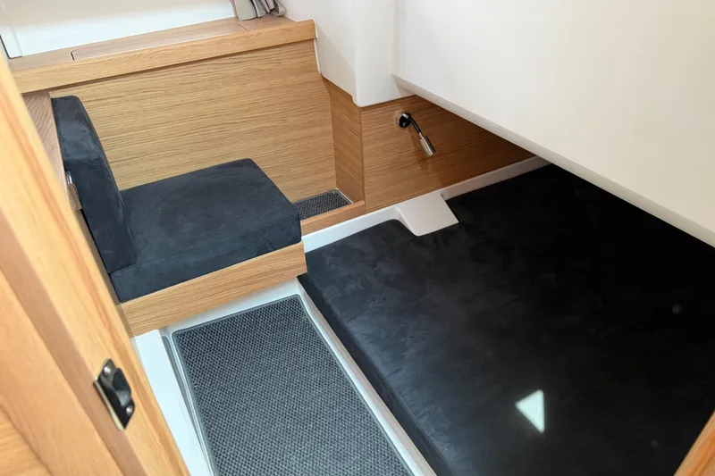 Slide: The Image of Interior of 2025 Nimbus Tender 11, featuring sleek wood paneling and modern seating. - 32