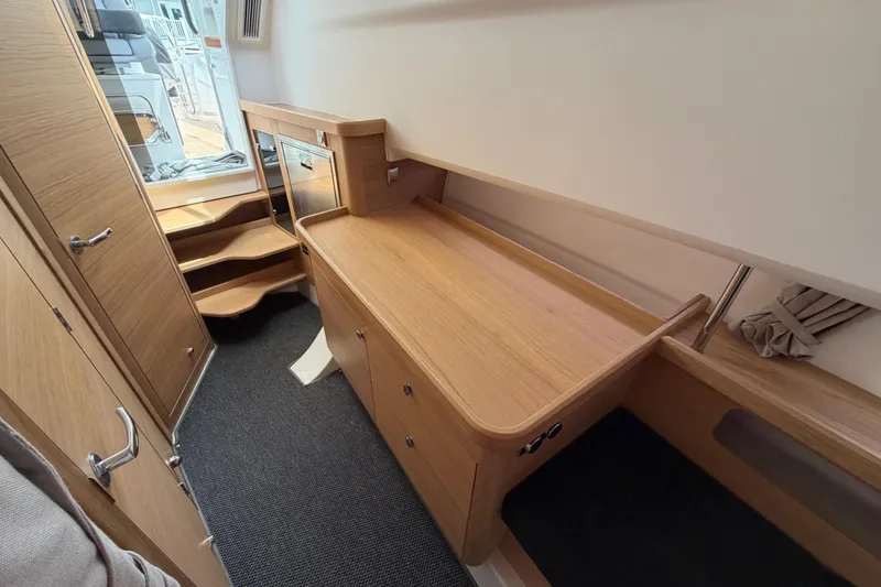 Slide: The Image of Interior of 2025 Nimbus Tender 11, featuring wooden cabinetry and stairs. - 35