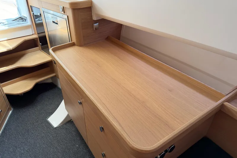 Slide: The Image of Interior of 2025 Nimbus Tender 11, featuring wooden cabinetry and steps. - 36