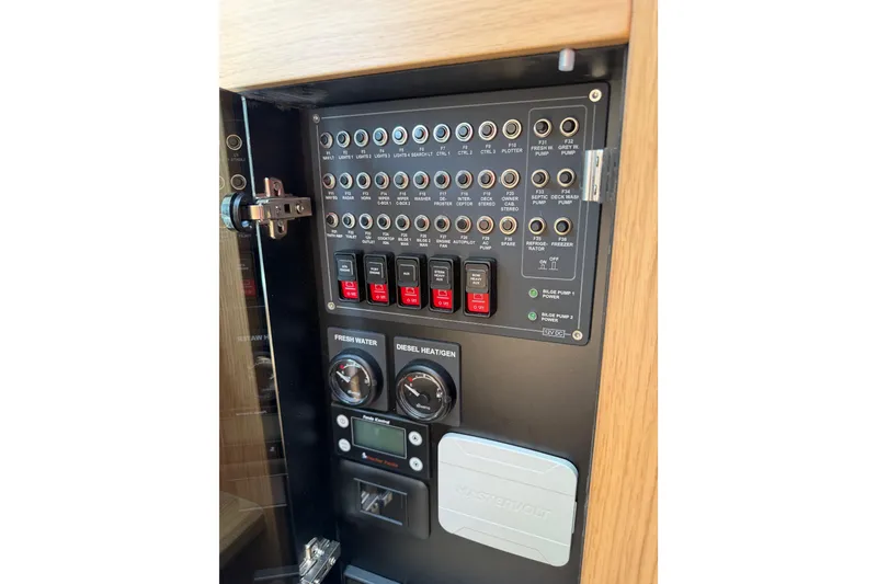 Slide: The Image of Control panel of 2025 Nimbus Tender 11 boat, featuring switches and gauges. - 38